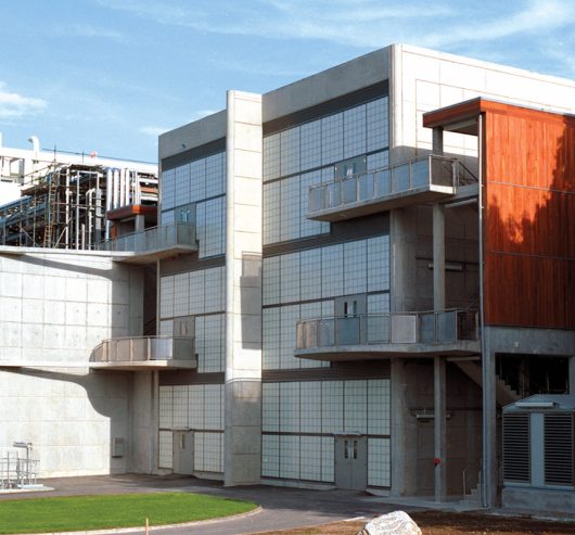 Building exterior featuring Kalwall curtain wall system of translucent panels with four balconies and one center column