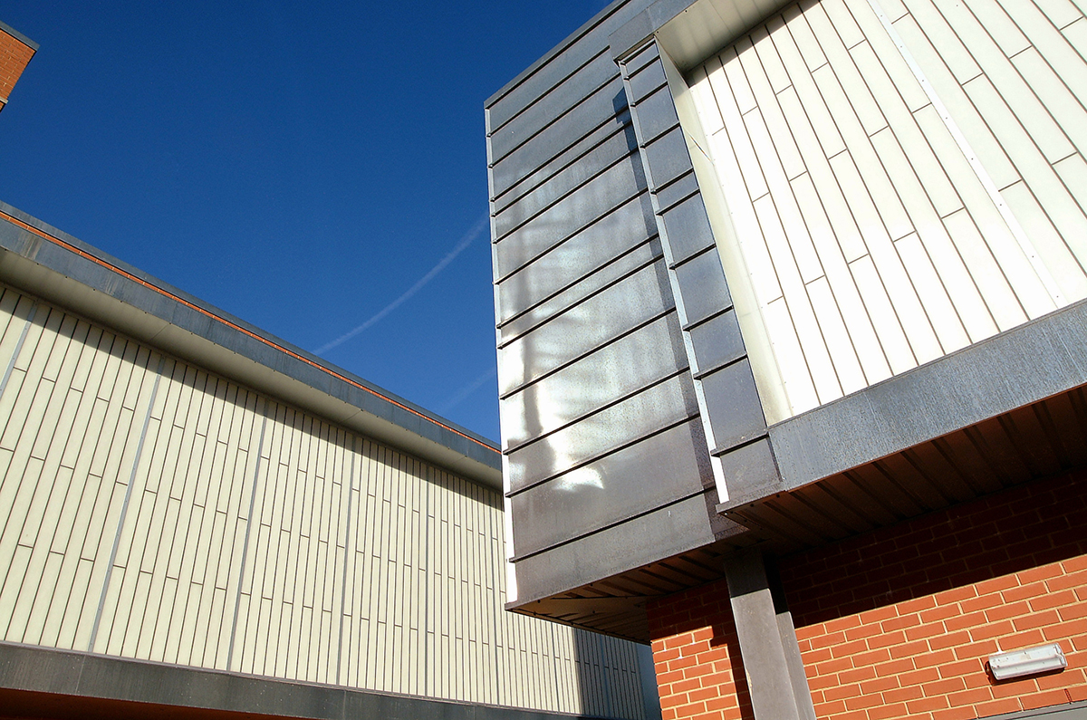 Brick building with Kalwall translucent facade system and metal paneling angled with another building with Kalwall panels