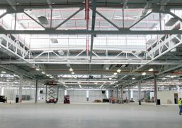 Industrial building featuring sections of Kalwall translucent wall panels among white piping and mechanical features