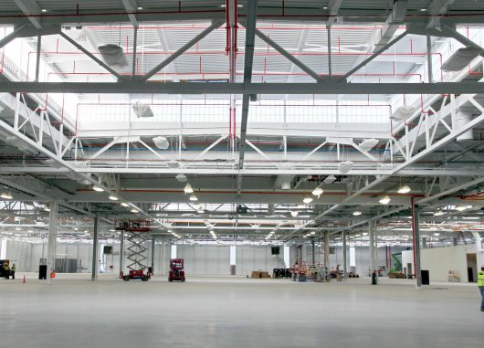 Industrial building featuring sections of Kalwall translucent wall panels among white piping and mechanical features