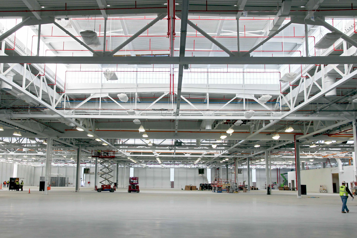 Industrial building featuring sections of Kalwall translucent wall panels among white piping and mechanical features