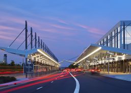 RDU airport exterior showcasing Kalwall Vertikal&trade; grid pattern on curtain wall system at sunset with blurred lights from cars