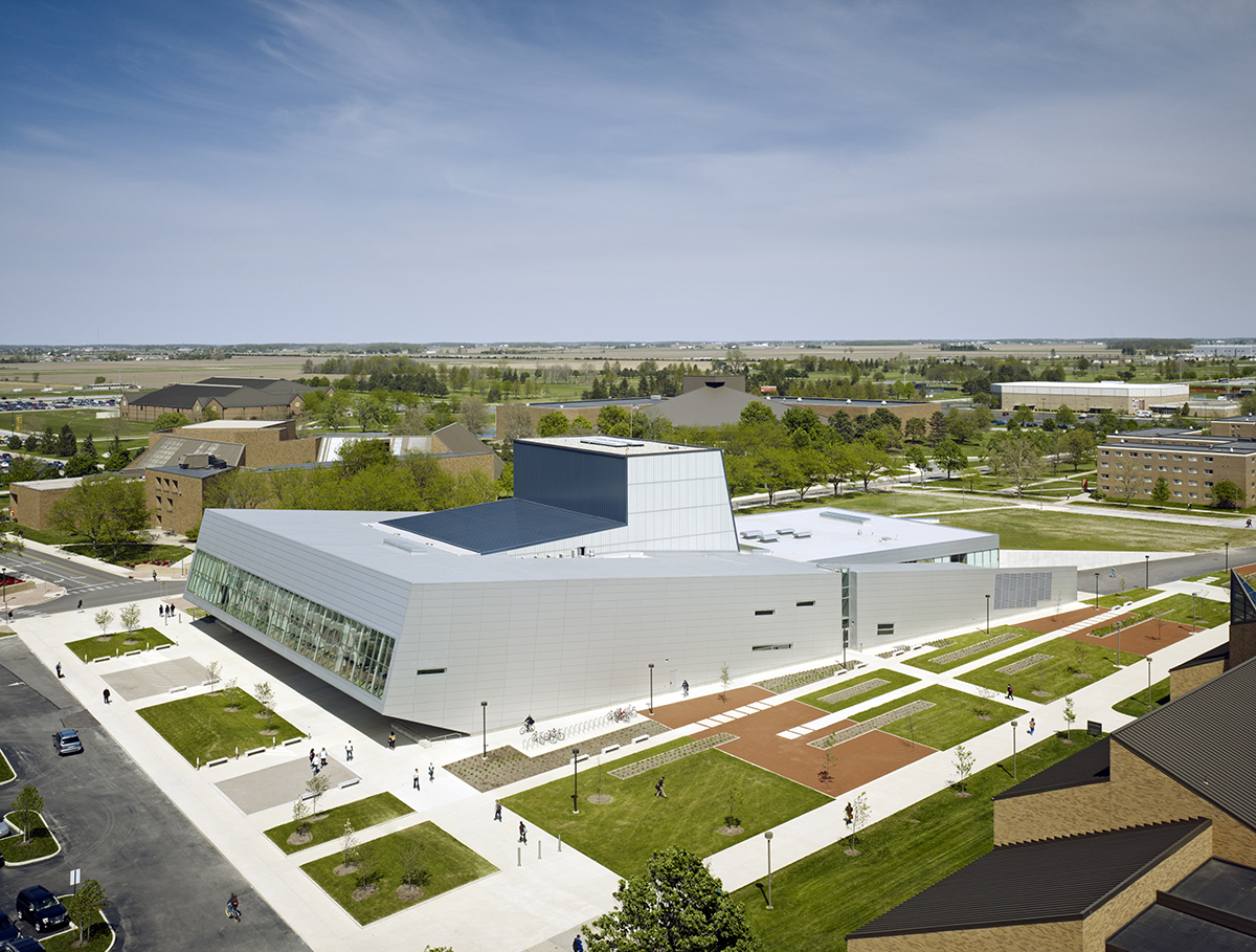 Wolfe Center for the Arts exterior with metal building and Kalwall facade inlay with students walking around building