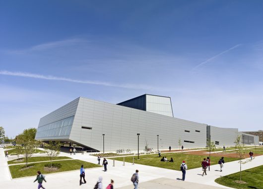 Wolfe Center for the Arts exterior with metal building and Kalwall facade inlay with students walking around building