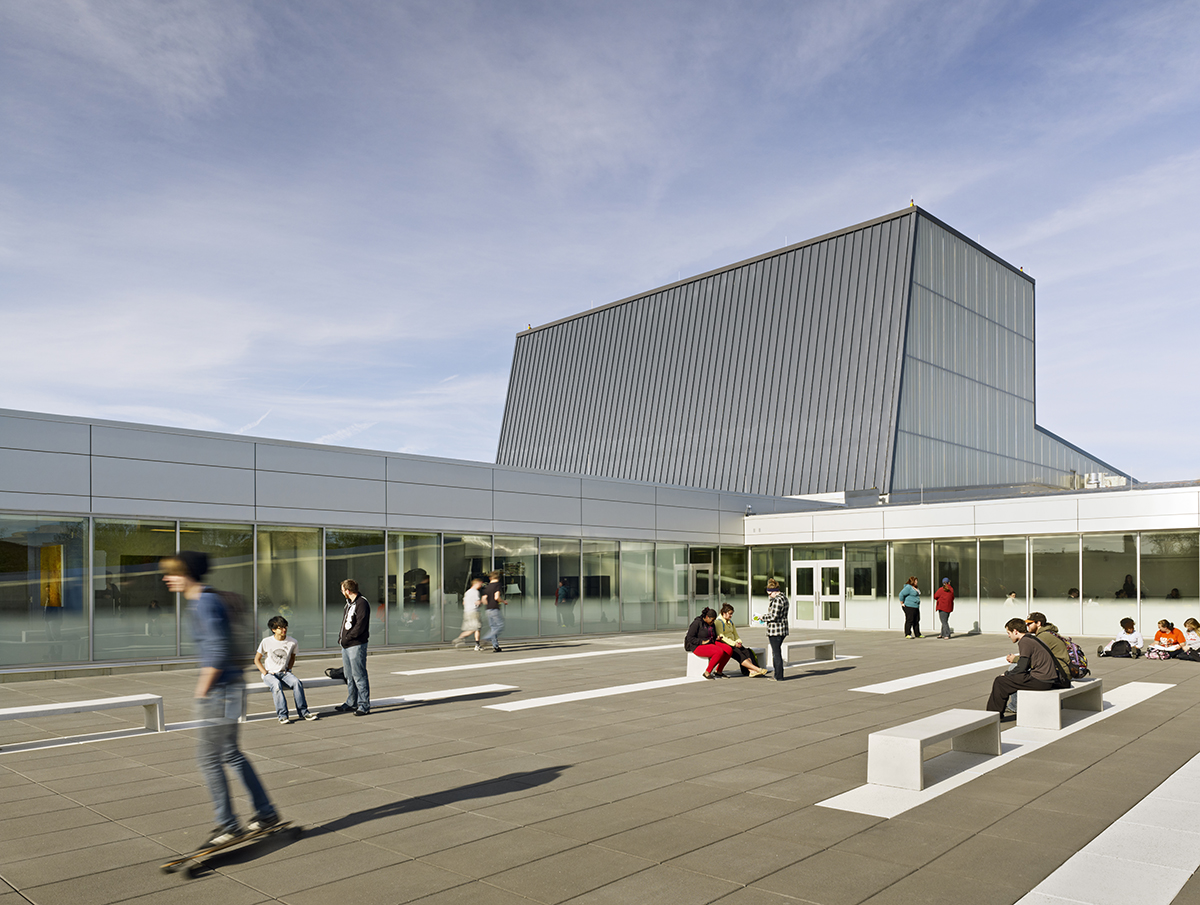 Wolfe Center for the Arts exterior with metal building and Kalwall facade inlay with students walking around building