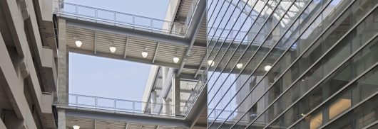 Multistory parking garage for shopping center featuring curved Kalwall skyroof&reg; application over walkway connecting buildings
