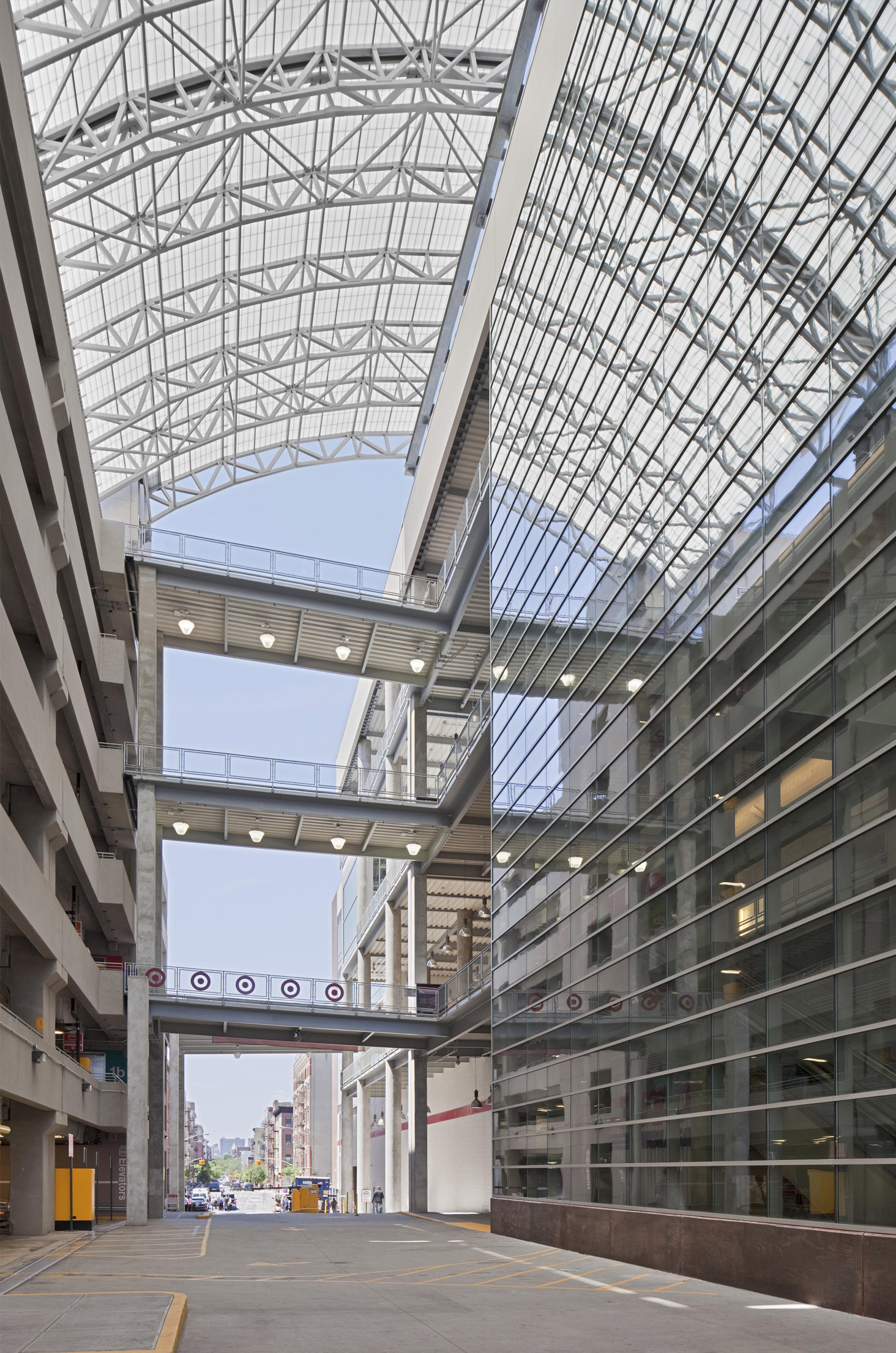 Multistory parking garage for shopping center featuring curved Kalwall skyroof&reg; application over walkway connecting buildings