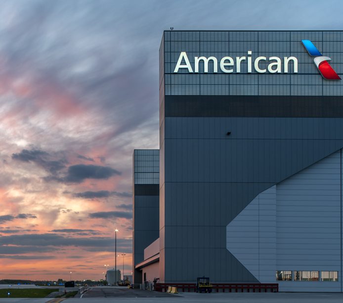 Kalwall facade featured on American Airlines Hangar 2 at Chicago O'Hare International Airport surrounded by colorful sunset