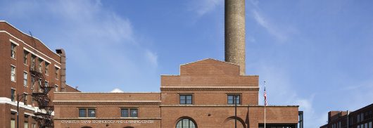 Brick exterior of Charles Shaw Technology and Learning Center featuring curved Kalwall panels in windows