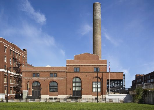 Brick exterior of Charles Shaw Technology and Learning Center featuring curved Kalwall panels in windows