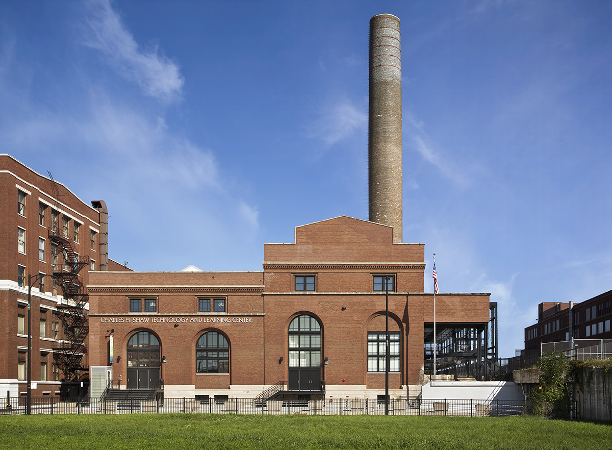 Brick exterior of Charles Shaw Technology and Learning Center featuring curved Kalwall panels in windows