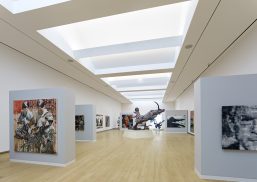 Crocker Art Museum interior with wood floors and artwork below hidden Kalwall skylight system