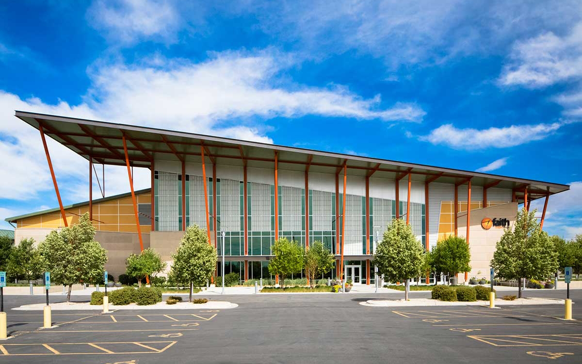 Faith Chapel with multiple sections of Kalwall translucent sandwich panels on building with sloped roof in front of blue sky