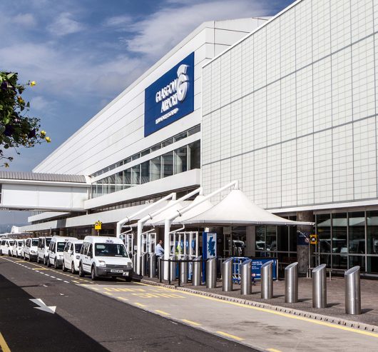 Glasgow Airport terminal exterior with Kalwall daylighting facade system, showcasing natural light integration and structural design in transportation environments.