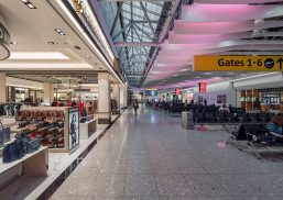 Heathrow Airport Terminal 4 interior with Kalwall clearspan™ skylight system above gate area with purple-hued lights