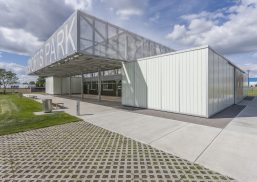 John Fry Sports Park Pavilion exterior under blue sky with clouds featuring cube-like modules with Kalwall translucent facade