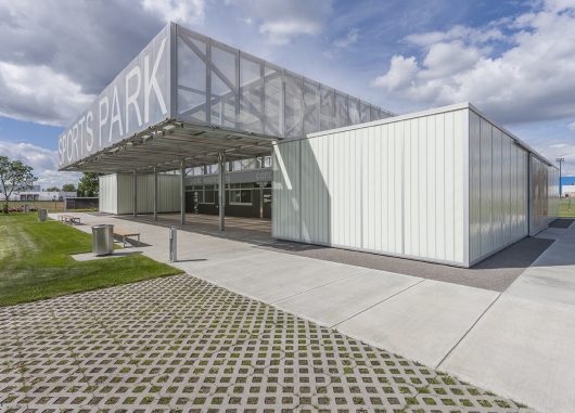 John Fry Sports Park Pavilion exterior under blue sky with clouds featuring cube-like modules with Kalwall translucent facade