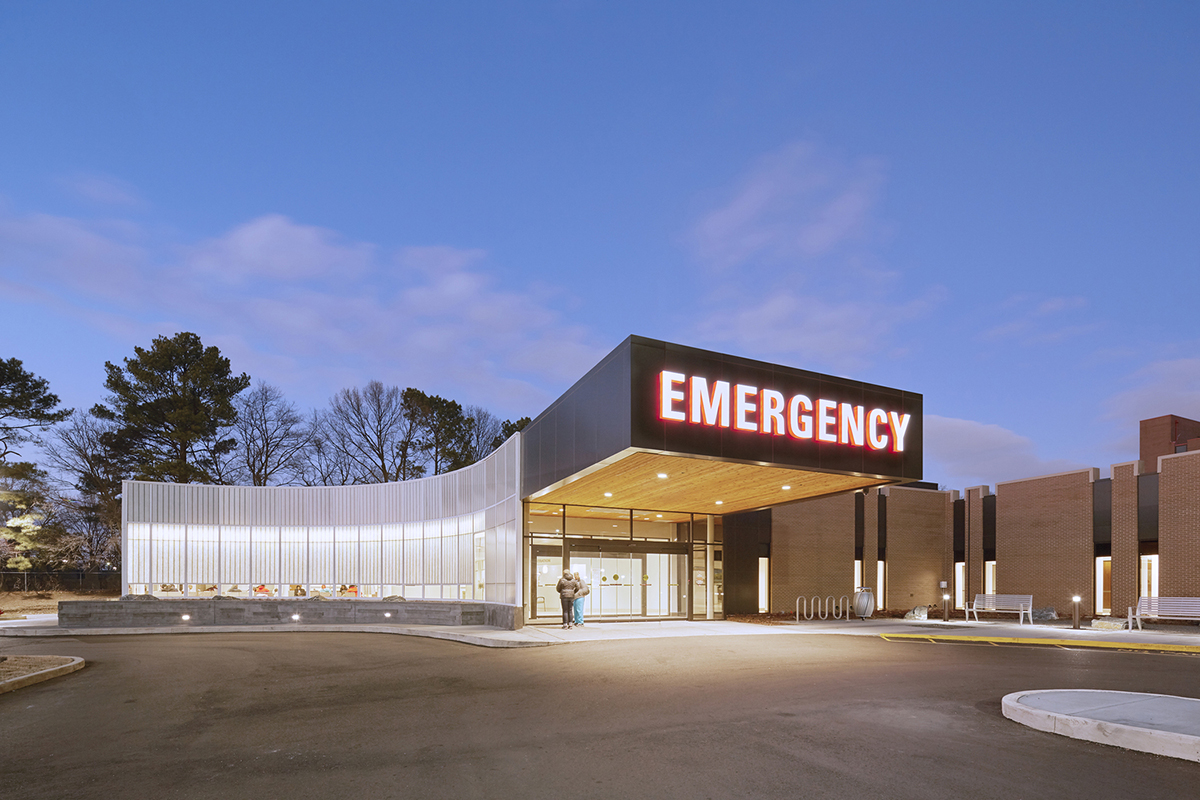 Curved Kalwall wall system of FRP panels on exterior of Methodist South emergency room at nighttime with backlighting