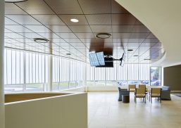 Interior view of the Methodist South ER Addition featuring Kalwall's translucent facade, modern seating area, and overhead monitors, emphasizing natural lighting and architectural design by brg3s architects.