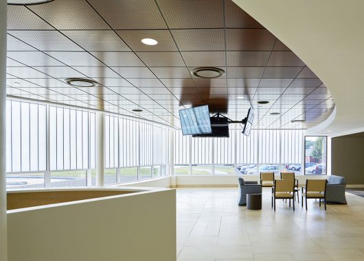 Interior view of the Methodist South ER Addition featuring Kalwall's translucent facade, modern seating area, and overhead monitors, emphasizing natural lighting and architectural design by brg3s architects.