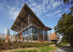 Exterior of New Belgium Brewery building with sloped roof featuring aluminum beams and Kalwall facade of wall panels