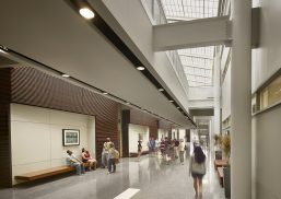 Stockton Campus Center interior featuring students walking below Kalwall translucent roof panels in skylight application