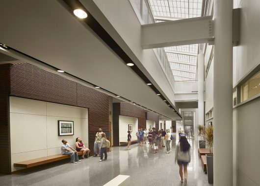 Stockton Campus Center interior featuring students walking below Kalwall translucent roof panels in skylight application