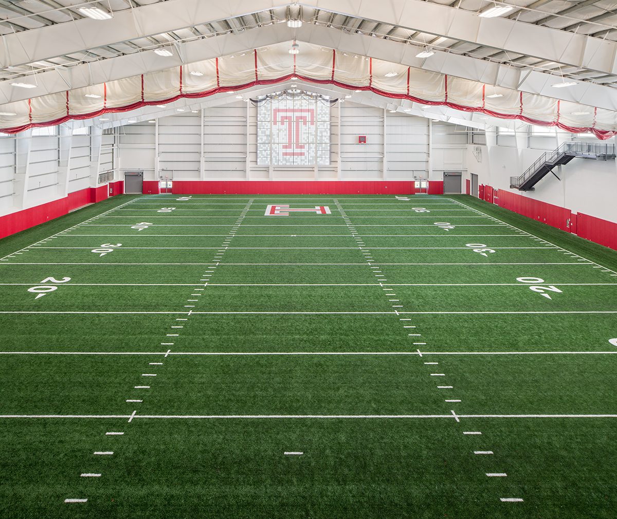 Interior of Temple University football practice facility featuring Kalwall wall system in window with colored inserts.