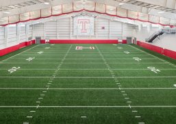 Interior of Temple University football practice facility featuring Kalwall wall system in window with colored inserts.