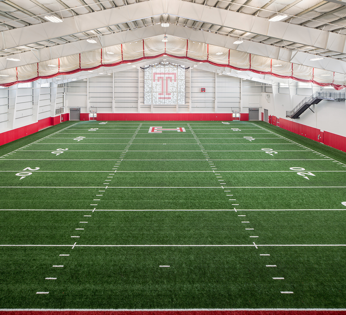 Interior of Temple University football practice facility featuring Kalwall wall system in window with colored inserts.