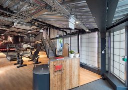 Interior of Dale Youth Amateur Boxing Club featuring front desk and athletic equipment in front of Kalwall wall panel system