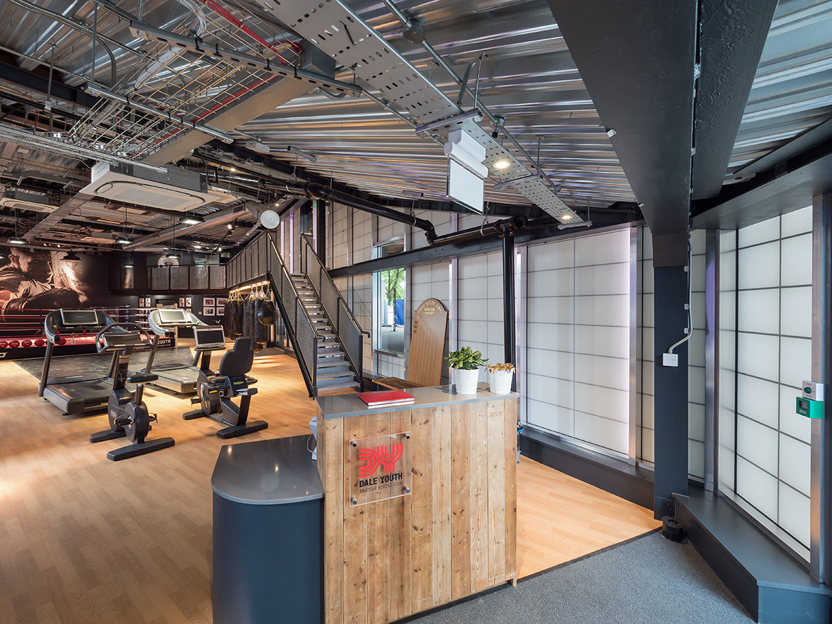 Interior of Dale Youth Amateur Boxing Club featuring front desk and athletic equipment in front of Kalwall wall panel system