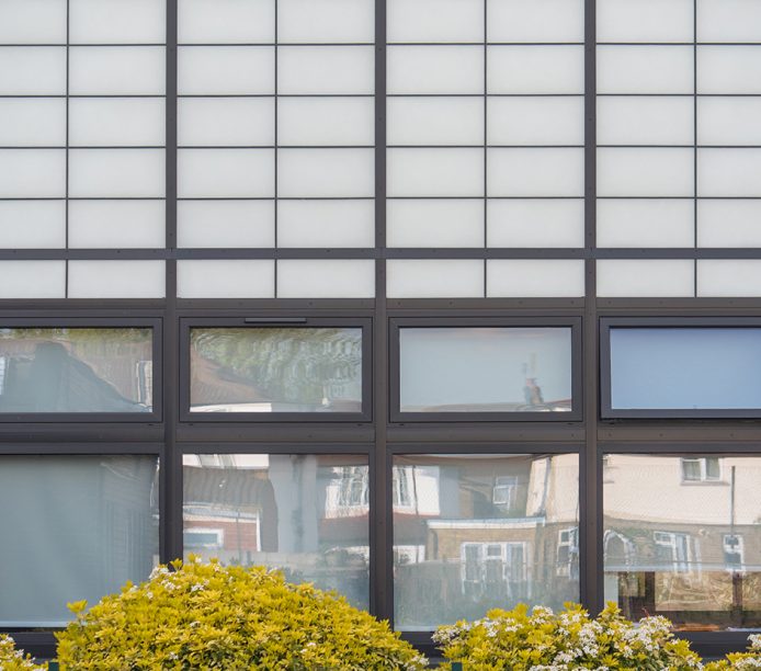 Featherstone High School exterior featuring Kalwall facade application combined with unitized panels for view to outside