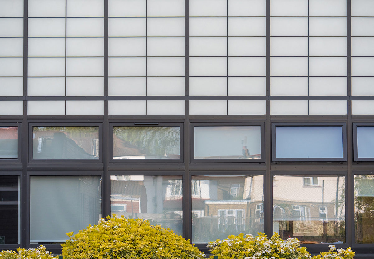 Featherstone High School exterior featuring Kalwall facade application combined with unitized panels for view to outside