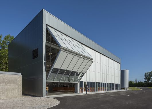 Fermilab exterior shot with unitized curtain wall system with one set of wall panels opening to reveal inside