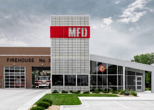 Manhattan Fire Department exterior with Kalwall wall system grid of FRP panels and red overlay with MFD cutout letters