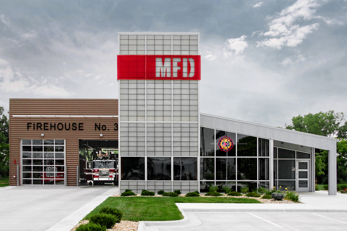 Manhattan Fire Department exterior with Kalwall wall system grid of FRP panels and red overlay with MFD cutout letters
