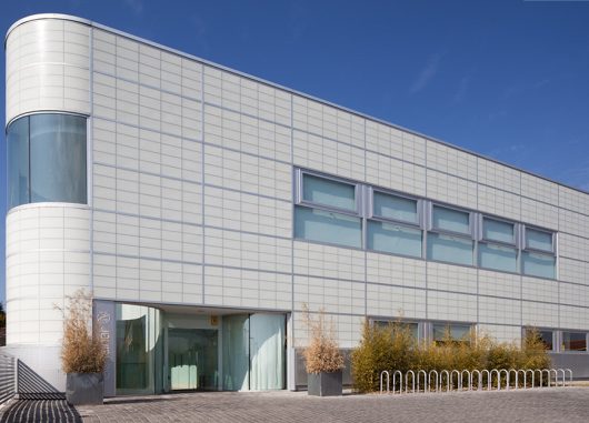 Sports Club exterior in Madrid, Spain, featuring translucent daylighting facade with Kalwallwall panels and unitized windows