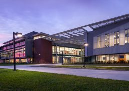 Tidewater Community College exterior at sunset featuring Kalwall unitized curtain wall system with Vertikal™ grid