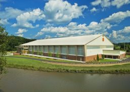 Clemson indoor football practice facility exterior under blue sky with clouds featuring wall of Kalwall translucent facades