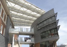 University of Cincinnati Student Life Center featuring two buildings attached by walkway with Kalwall canopy above