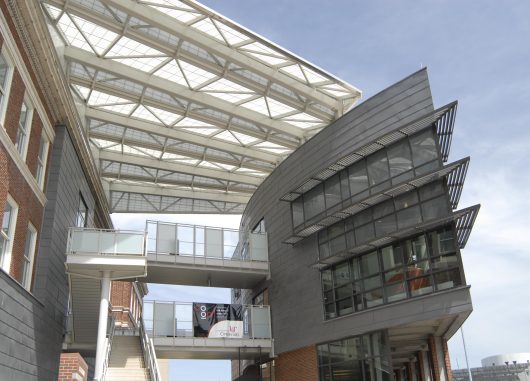 University of Cincinnati Student Life Center featuring two buildings attached by walkway with Kalwall canopy above