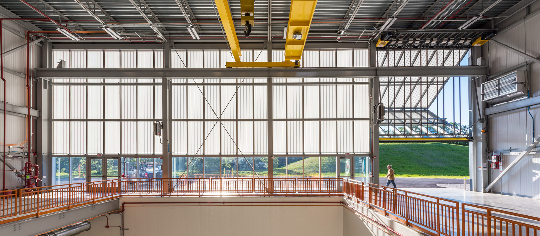 Interior of industrial building featuring Kalwall facade with unitized glass panels providing a view to outside