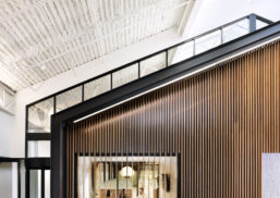 Northpointe Bank Interior with angled ceiling and wood-paneled wall.