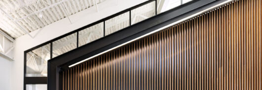 Northpointe Bank Interior with angled ceiling and wood-paneled wall.