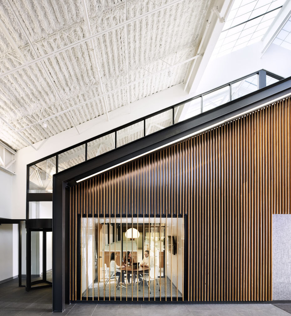 Northpointe Bank Interior with angled ceiling and wood-paneled wall.