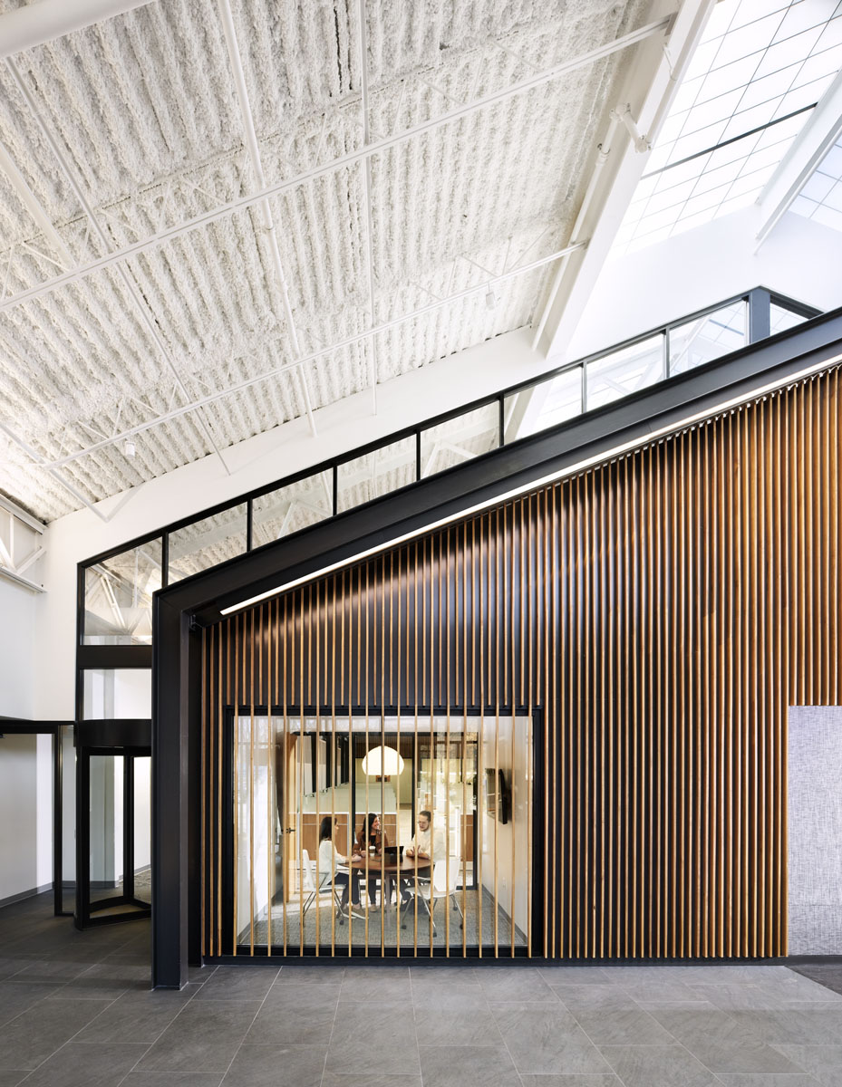 Northpointe Bank Interior with angled ceiling and wood-paneled wall.