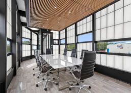 Interior of the Frank's Ice Cream office with a conference table and chairs set among a Kalwall facade with unitized windows.