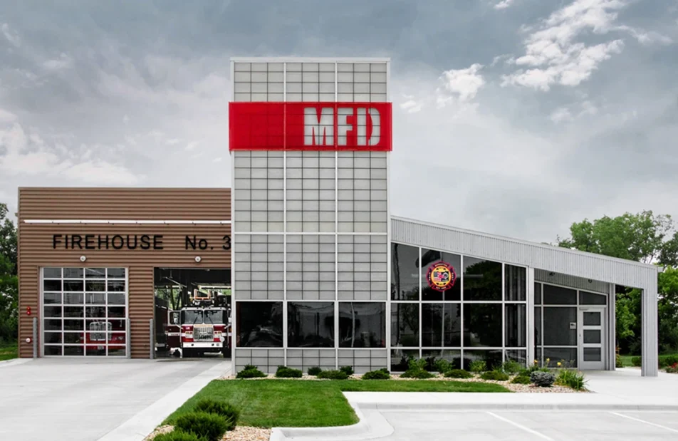 Image of Manhattan Fire Department exterior with Kalwall wall system grid of FRP panels and red overlay with MFD cutout letters Manhattan Fire Station